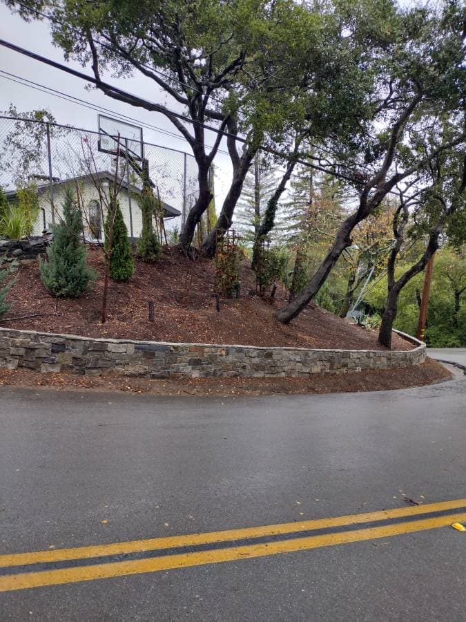 Retaining wall installation for hillside erosion control and landscape support