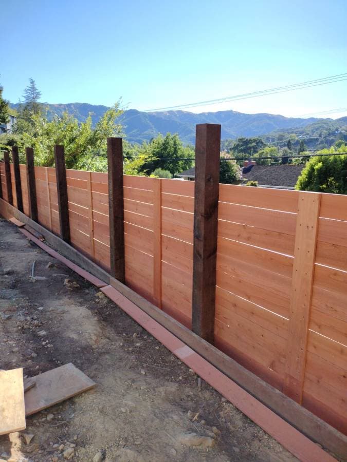 Wood fence installation providing privacy and property boundary definition