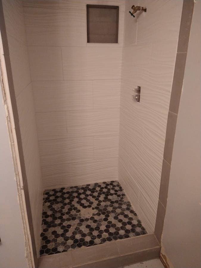 Bathroom wall repair and tile preparation during interior handyman project